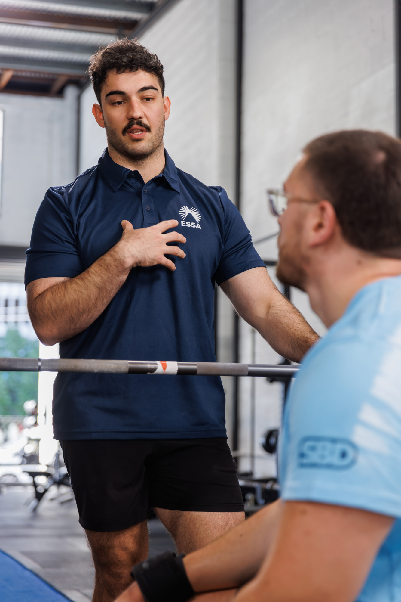 Chris Anastasiou, Accredited Exercise Physiologist, coaching a client through a movement pattern