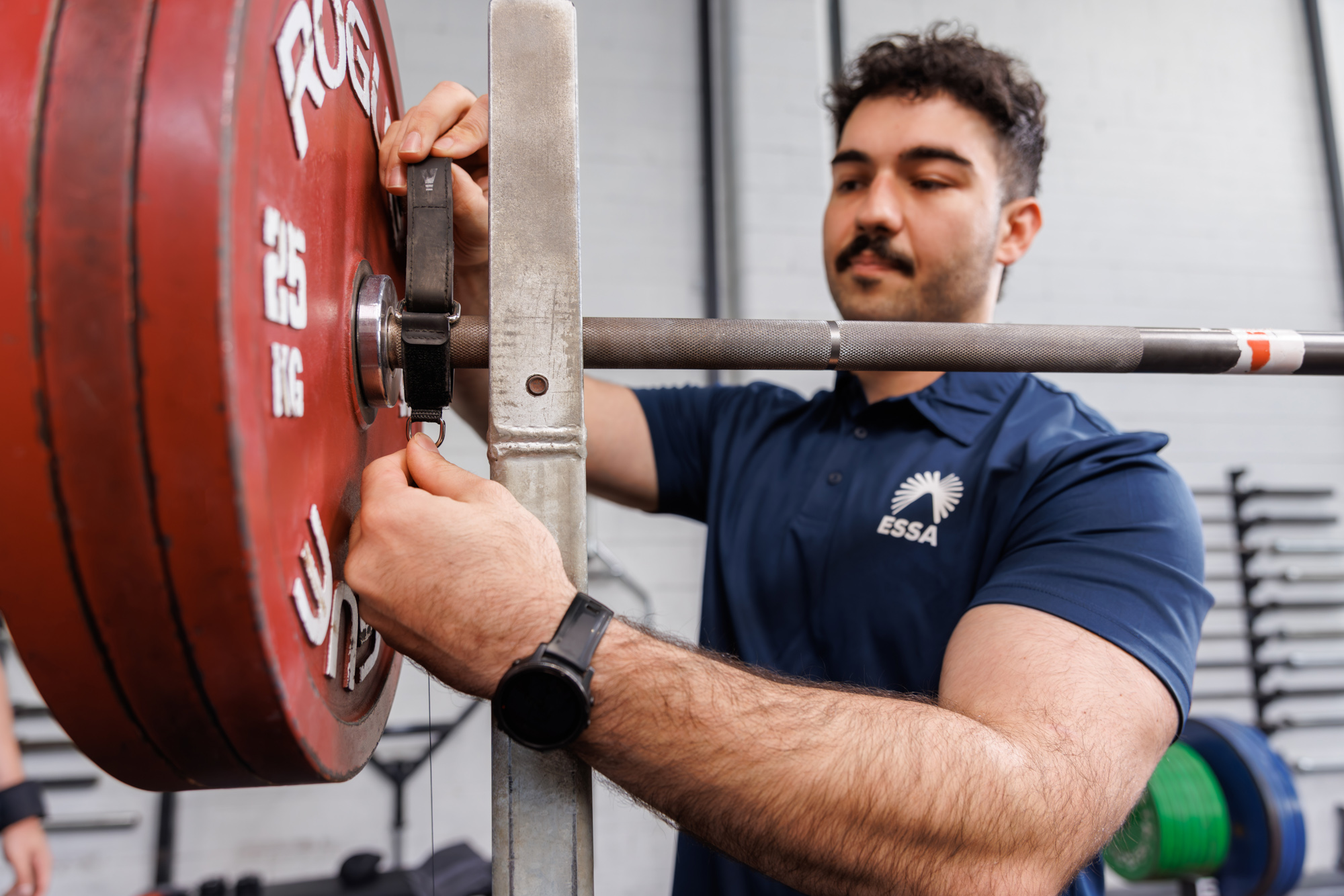 Chris preparing a barbell for a supervised strength session